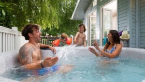 Family splashing mum in hot tub