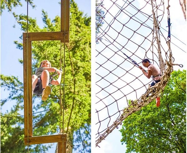 A boy walking on a tree top maze challenge and a girl that fell on a net