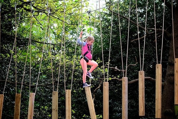 A girl crossing at the thrilling rickety bridge