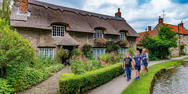 Group of people with teenagrs walking near the lake in Yorkshire