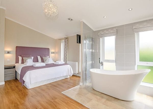 Lode Hall Lodges bedroom with bath tub