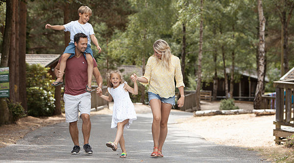 Family strolling through the warmwell holiday park